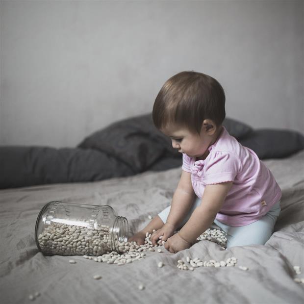 baby playing on bed